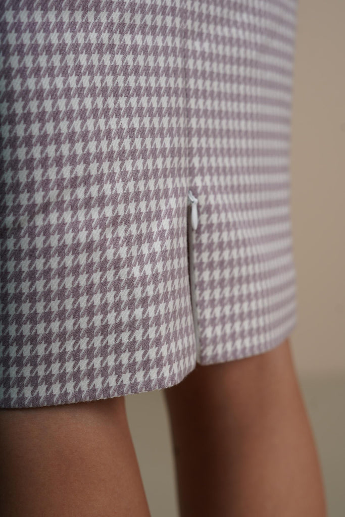 Detail of hidden zipper and button closure on lilac wool pencil skirt