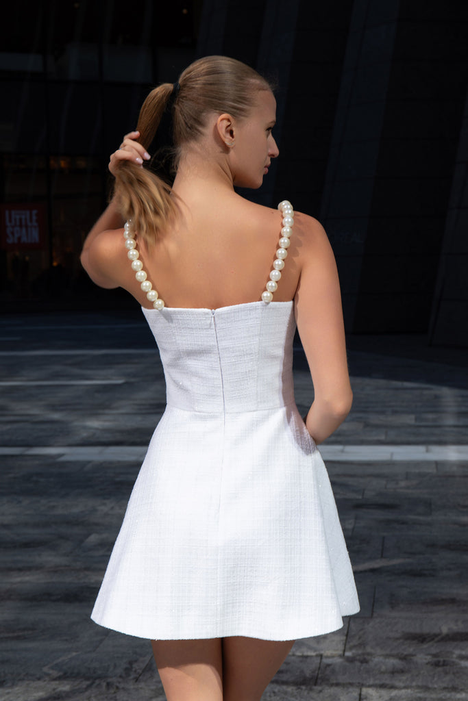 Back view of white tweed sundress with pearl straps by Anastasiia Ivanova, showcasing concealed zipper and refined tailoring
