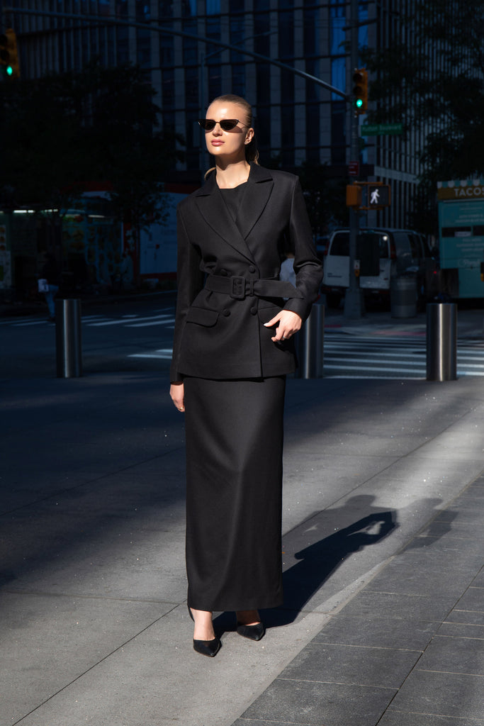 Full-length view of the Total Black look by Anastasiia Ivanova featuring a black belted blazer and matching black maxi dress, captured in New York City