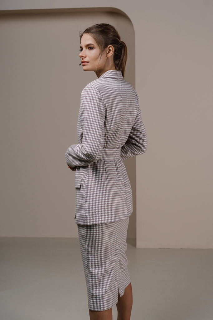 Side profile view of high-waisted midi pencil skirt in pastel lilac houndstooth
