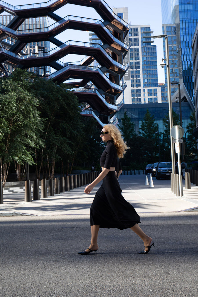 Black flared midi skirt by Anastasiia Ivanova, elegant street style captured in New York