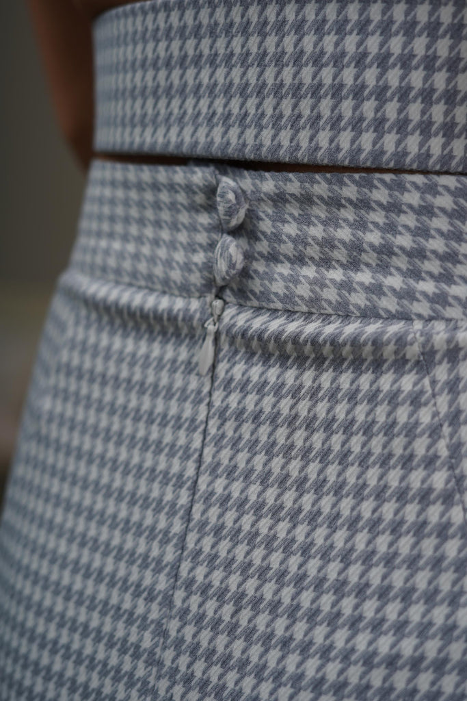 Back view showing slit detail of midi skirt in lilac houndstooth wool