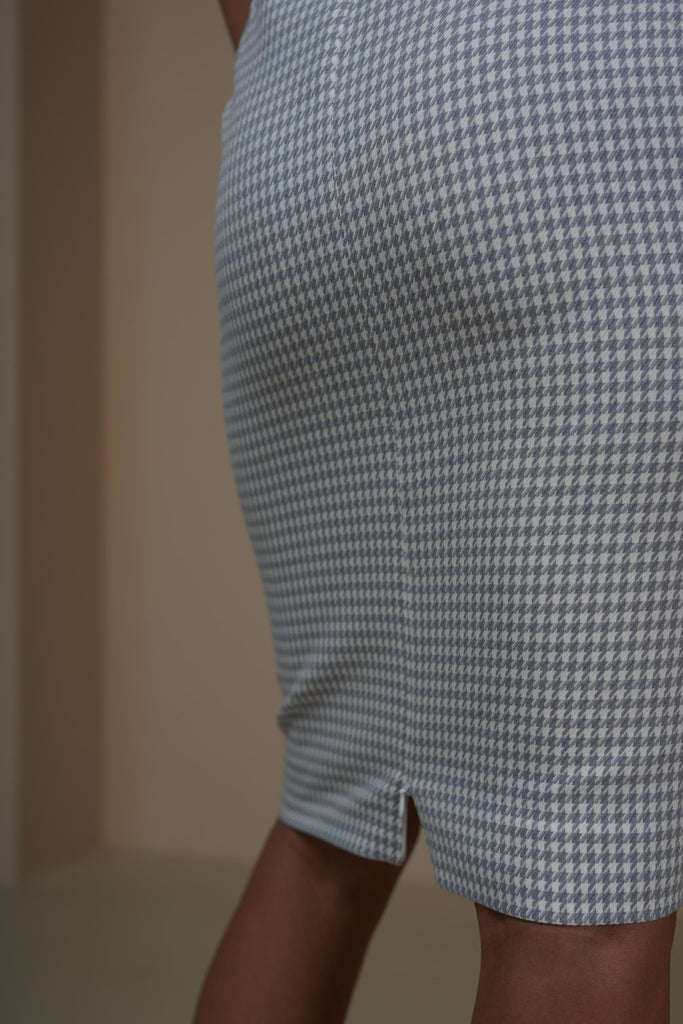 Back view showing slit detail of midi skirt in lilac houndstooth wool