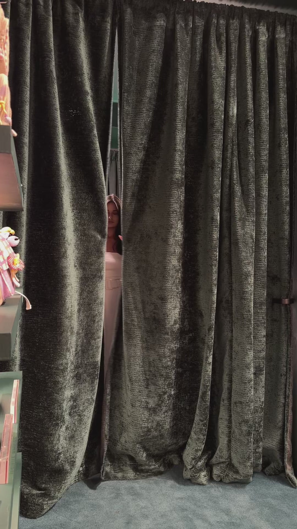 A woman in a fitting room trying on an elegant white strapless civil wedding dress. Showcasing the flawless architectural fit, premium high-density fabric, and high-end craftsmanship by Anastasiia Ivanova.