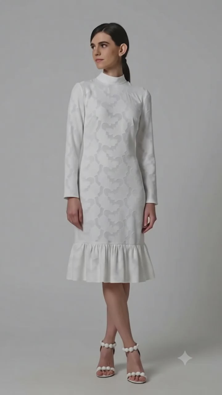 Video showcasing an elegant white textured midi dress by Anastasiia Ivanova. The footage highlights the luxurious raised fabric pattern, long sleeves, mock neckline, and a playful flounce hem, presenting a perfect sophisticated look for a civil wedding or rehearsal dinner.